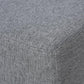 Gray textured fabric corner seam on a cube ottoman foot rest