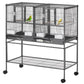 Divided metal bird cage with two sections, wood perches, and rolling stand