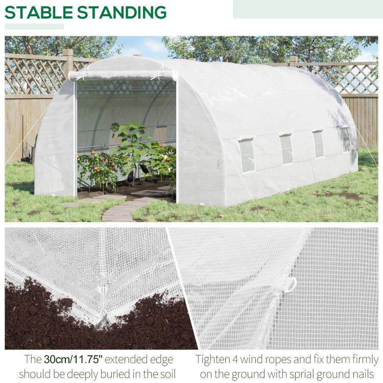 White tunnel greenhouse on outdoor ground with zippered door and mesh windows