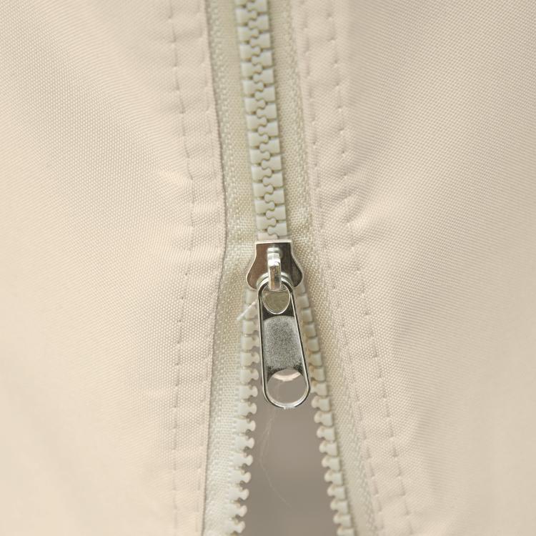 Beige gazebo sidewall panel detail: zipper track with metal hook and C-ring