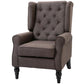 Wingback lounge chair with rounded arms, tufted back, and dark fabric upholstery