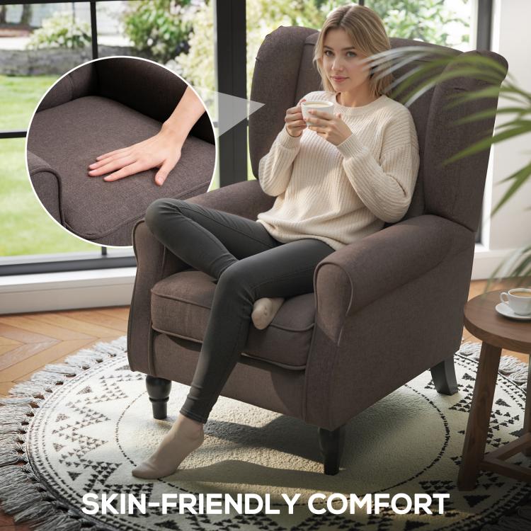Dark upholstered wingback chair with rounded arms and supportive seat cushioning