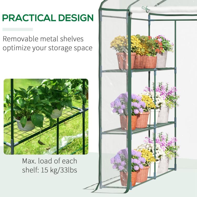 Clear mini walk-in greenhouse with green frame and metal shelves for potted plants