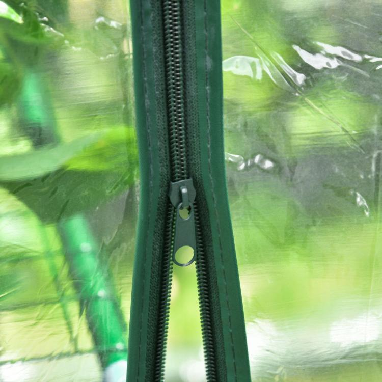 Close-up of greenhouse zippered door track on green frame with transparent PE cover