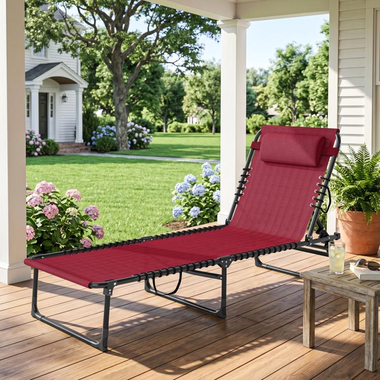 Wine red folding lounge chair with padded headrest and black bungee straps
