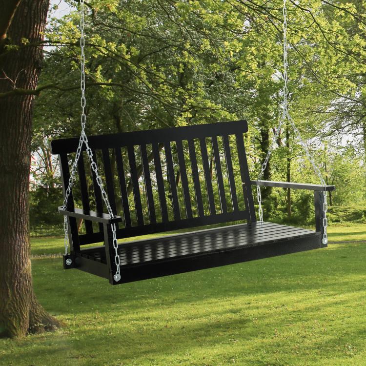 Black hanging porch swing chair with slatted back and seat, hanging from metal chains