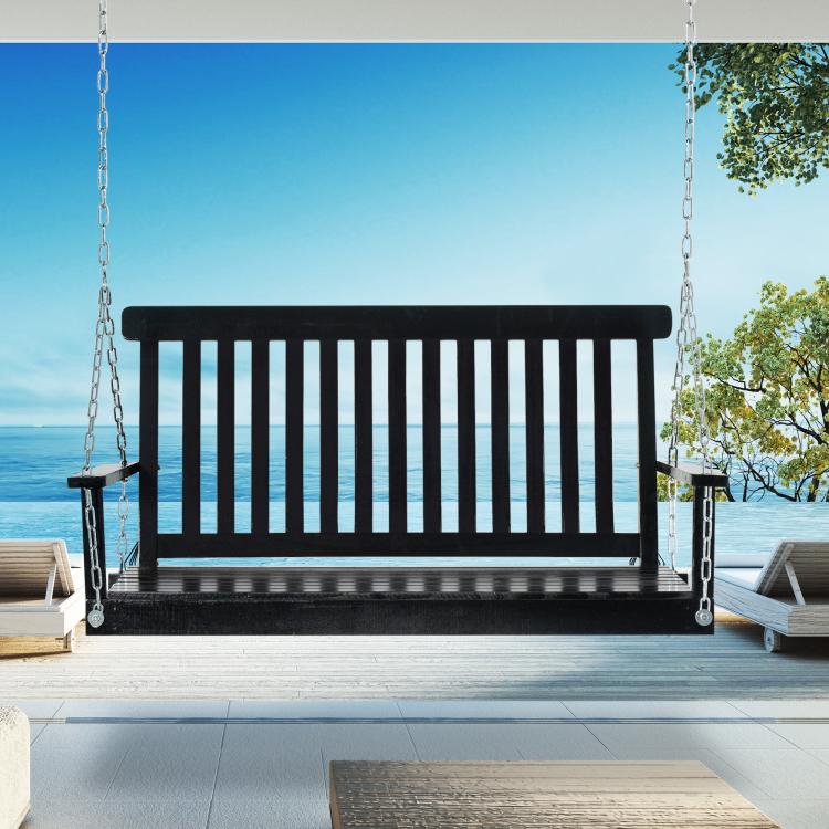 Black hanging porch swing chair with slatted back and seat, suspended from metal chains