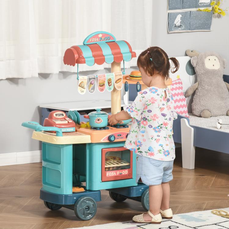 Kids play kitchen food stand cart with oven window and play utensils, shown with a child