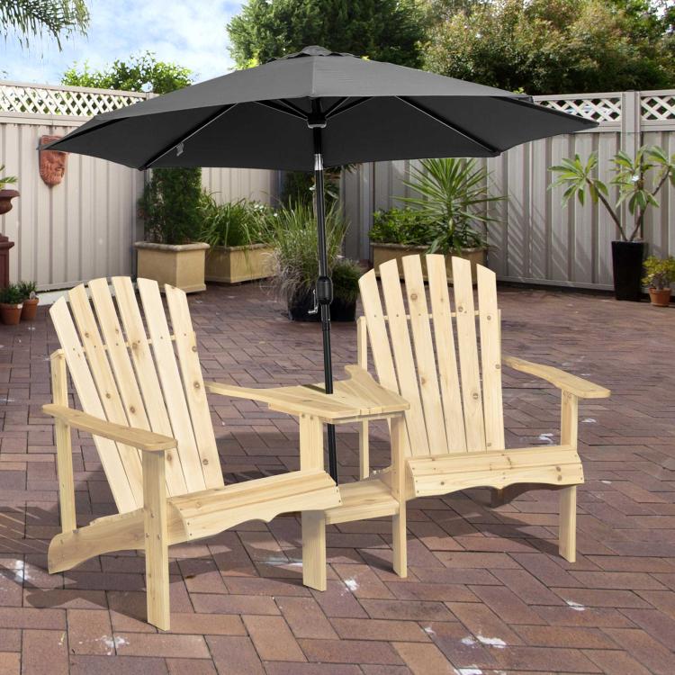 Natural wood two-person Adirondack bench with overhead black umbrella outdoors.