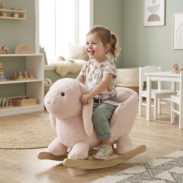 Plush rabbit rocking horse with wooden rockers, toddler sitting and holding on