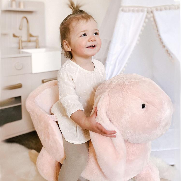 Plush rabbit rocking horse with wooden rockers, toddler holding the rabbit