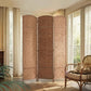 3-panel folding wicker room divider standing in front of windows in a room