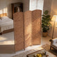 3-panel wicker room divider in a bedroom corner with arched woven screens