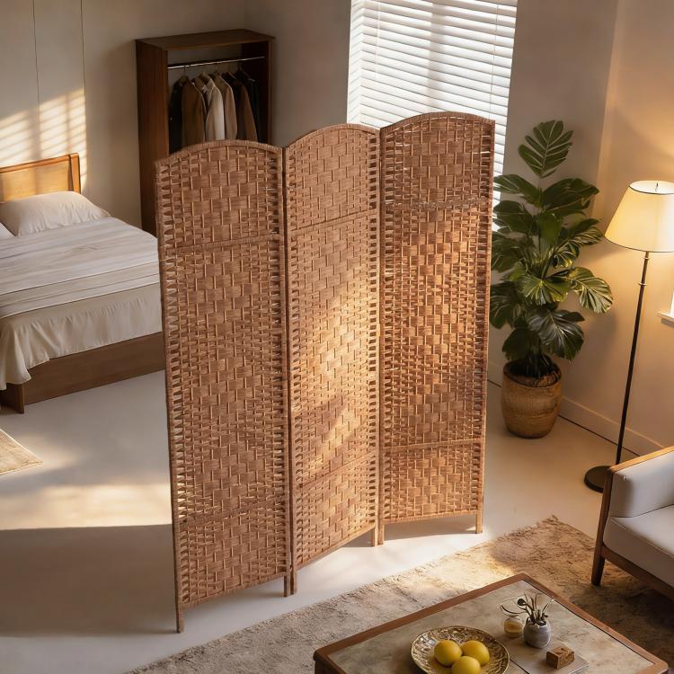 3-panel wicker room divider in a bedroom corner with arched woven screens