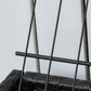 Raised planter bed frame with black metal grid and crossbar