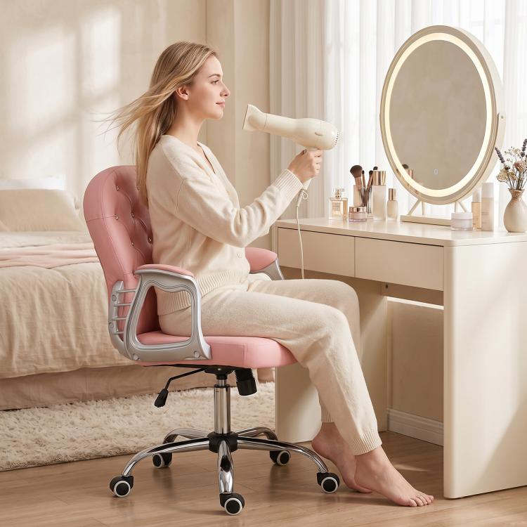 Pink button-tufted office chair with chrome base and rolling casters in use