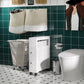 White narrow rolling bathroom storage cabinet with open shelf and drawer fronts
