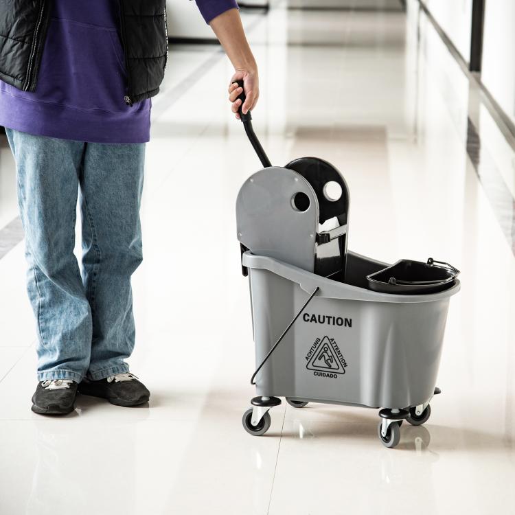 Gray mop wringer bucket cart with black basket and handle on four caster wheels