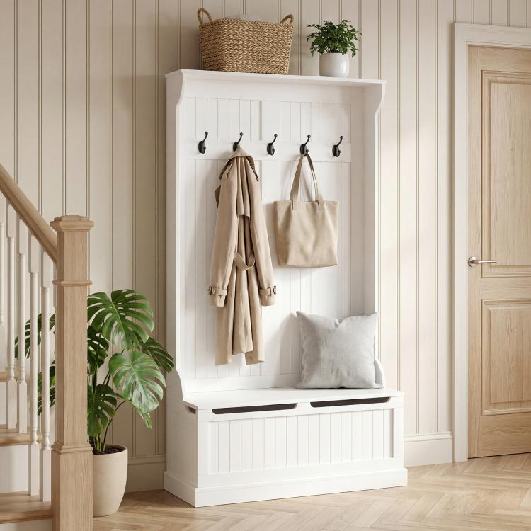 White hall tree bench with five coat hooks and padded seat with cushions
