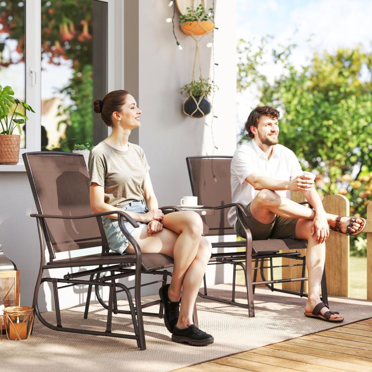Outdoor rocking chair set with two brown sling chairs and round coffee table on patio