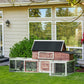 Wooden chicken coop with covered roof and three-section fenced run, door on front
