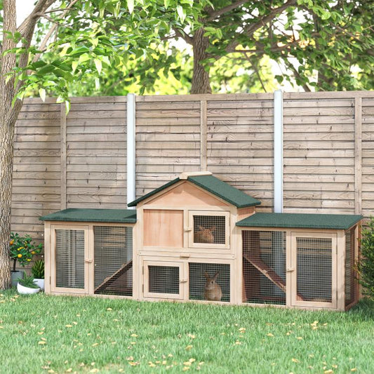 Two-story wooden rabbit hutch with mesh doors and green roof panels
