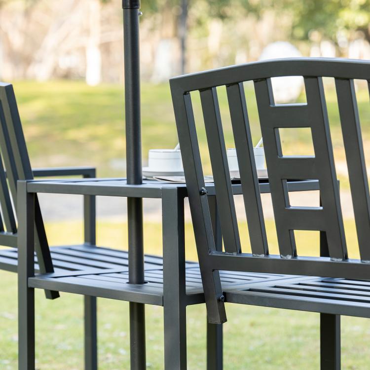 Black metal patio bench with slatted seats and middle table, umbrella-hole pole