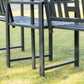 Close-up of dark metal bench legs and slatted seat on outdoor chair set