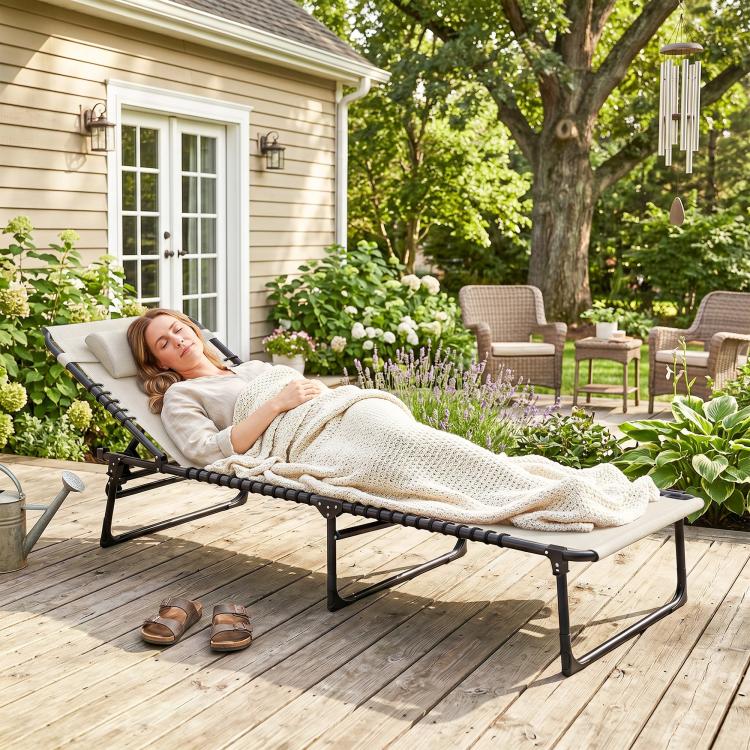 Cream folding chaise lounge pool chair with pillow and mesh seat for outdoor lounging