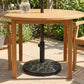 Black round resin umbrella base stand centered under a patio table