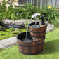 Two-tier wooden barrel fountain with black pump faucet and cascading water