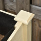 Close-up of black fabric planter liner tucked at corner of light wood bed frame
