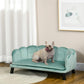 Green pet sofa bed with cushioned seat and tufted backrest, dark wooden legs