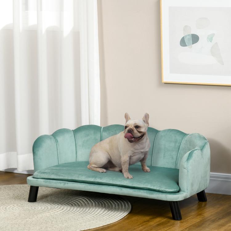 Green pet sofa bed with cushioned seat and tufted backrest, dark wooden legs