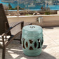 Antique blue ceramic garden stool with cutout double-coin ring pattern, circular seat top.