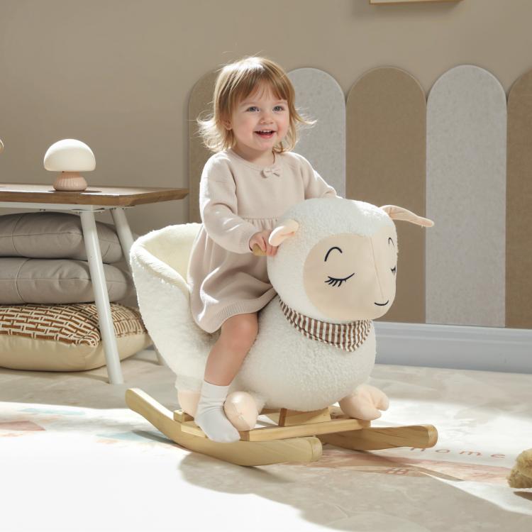 White plush rocking sheep with striped scarf; toddler sitting and holding on.