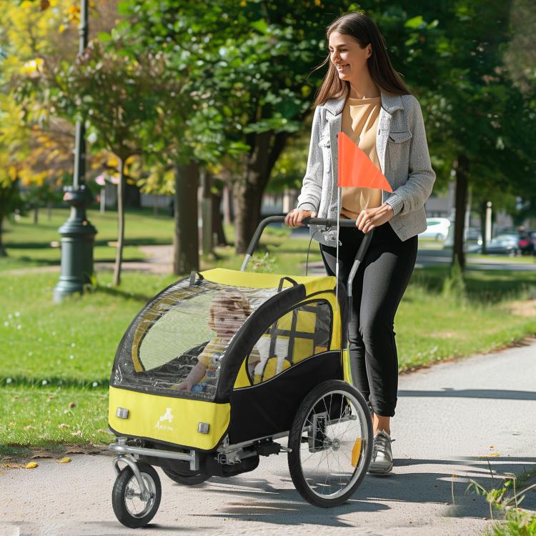 2-seat yellow and black bike trailer with curved canopy, mesh windows, and orange flag