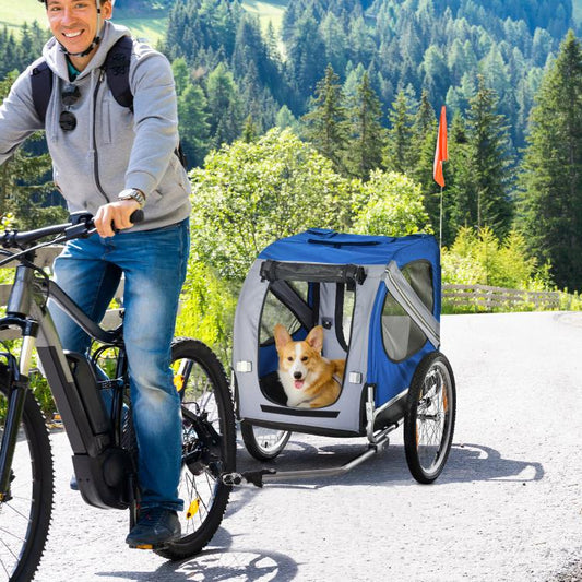 Dog bike trailer with blue cover and black mesh windows, dog visible inside during cycling