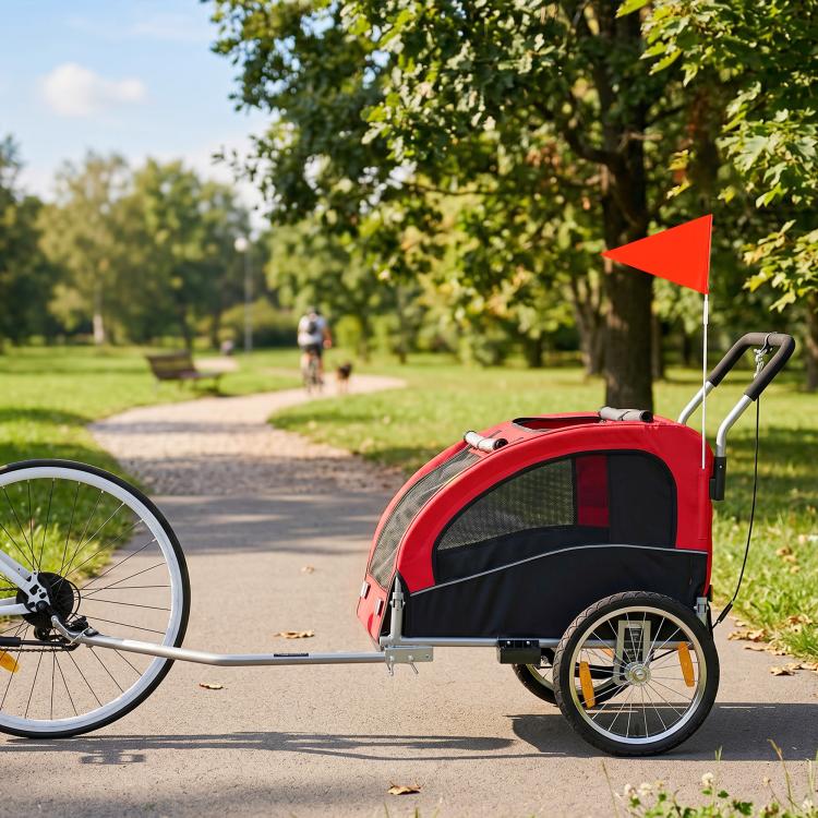 Red pet bike trailer stroller with black mesh sides and front window, two-wheel frame