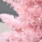 Pink slim artificial Christmas tree branches with warm white LED lights, close-up