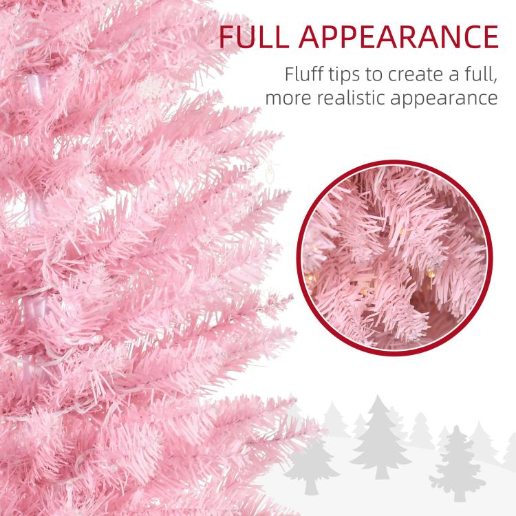 Pink artificial Christmas tree with dense tips close-up and warm white glow
