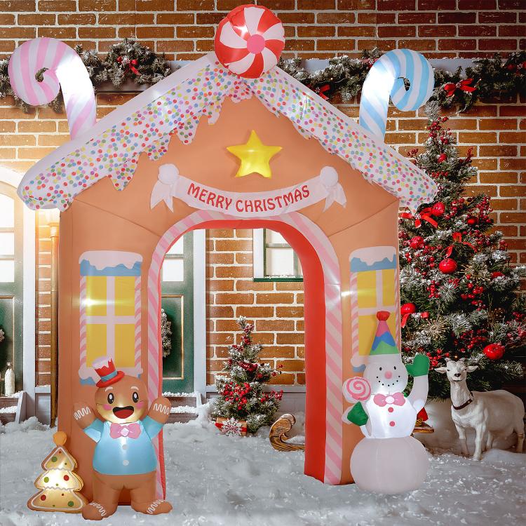 Candy house inflatable archway with gingerbread, snowman, and “Merry Christmas” banner top