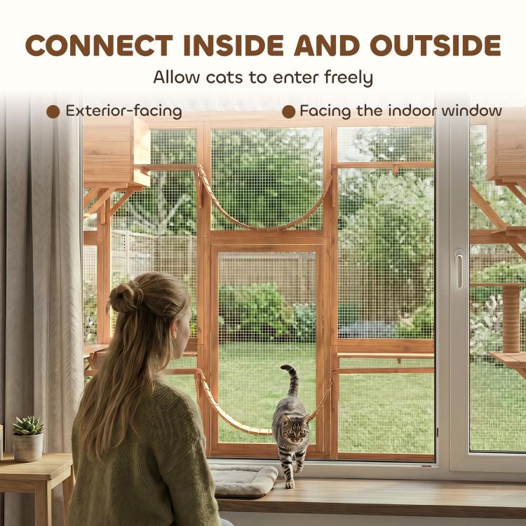 Wooden cat enclosure with mesh panels and a hanging hammock bridge near a window