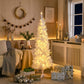 Slim white artificial Christmas tree lit with warm white LED lights, full profile