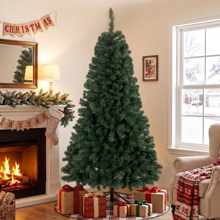 Artificial green Christmas tree with dense branches on metal stand