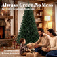 Artificial green Christmas tree with dense branches on black metal base stand