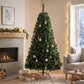 Decorated artificial green Christmas tree with ornaments and string lights on metal stand