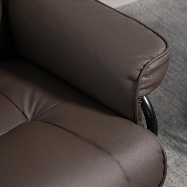 Brown padded reclining chair arm and seat close-up with smooth upholstery