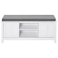 White shoe storage bench with gray upholstered cushion and open storage shelves