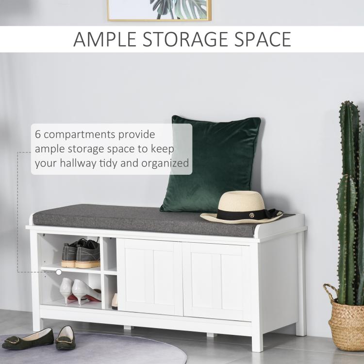 White shoe storage bench with gray cushioned seat and multiple shoe compartments